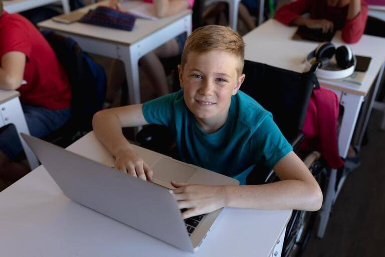 Ребёнок в классе за ноутбуком