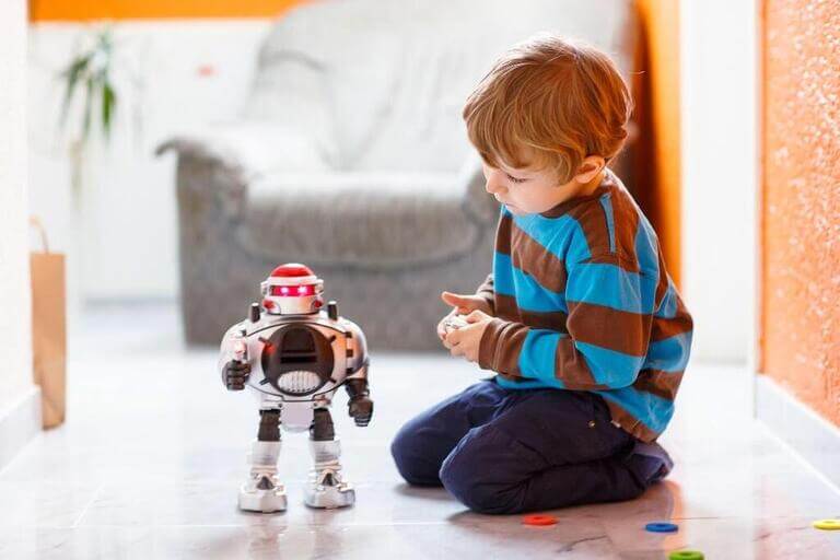 Мальчик играет с роботом